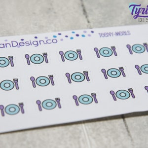 May include: A sheet of stickers with a white background and purple and blue illustrations of plates, forks, and spoons. The text "TEENY-MEALS" is printed at the top of the sheet.