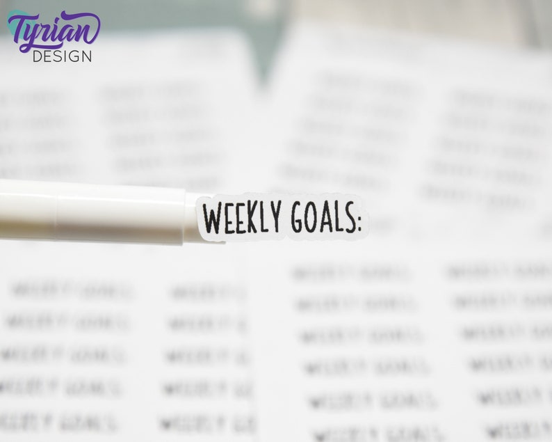May include: A white sticker with the text "WEEKLY GOALS:" printed in black.