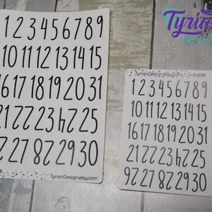 May include: Two sheets of white paper with black numbers 1 through 30 printed on them. The numbers are handwritten in a casual script font. The text "Tyrian Design" is printed on both sheets.