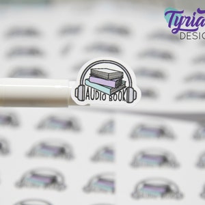 May include: A white sticker with a black and white illustration of a stack of books with headphones on top. The text "AUDIO BOOK" is written below the books.