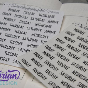 May include: A sheet of white sticker paper with black text. The text reads "MONDAY TUESDAY WEDNESDAY FRIDAY THURSDAY SATURDAY SUNDAY" repeated multiple times. The stickers are for use in a planner or journal.