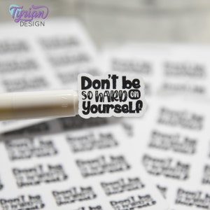 May include: A white sticker with black text that reads "Don't be so hard on yourself".