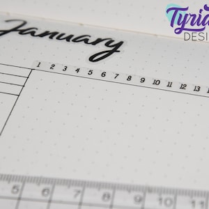 May include: A close-up of a blank calendar page with the word "January" written in black cursive at the top. The page is divided into sections with numbers 1 through 15 listed across the top.