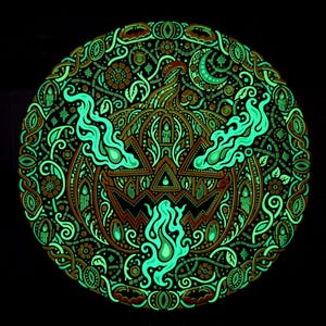 Complete Jack o’ the Shadows wall relief after the UV source is removed, showing retained green afterglow.