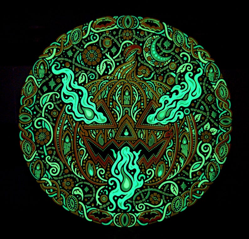 Complete Jack o’ the Shadows wall relief after the UV source is removed, showing retained green afterglow.