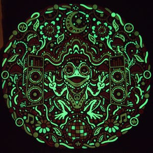 Bass Frog wall art showing its retained green glow in the dark after charging.