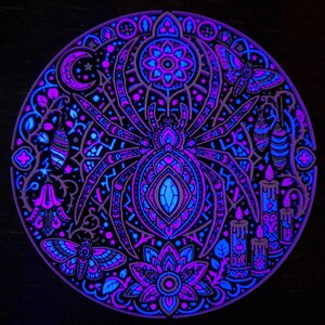 Complete Arachnomancer spider wall relief under active UV blacklight.
