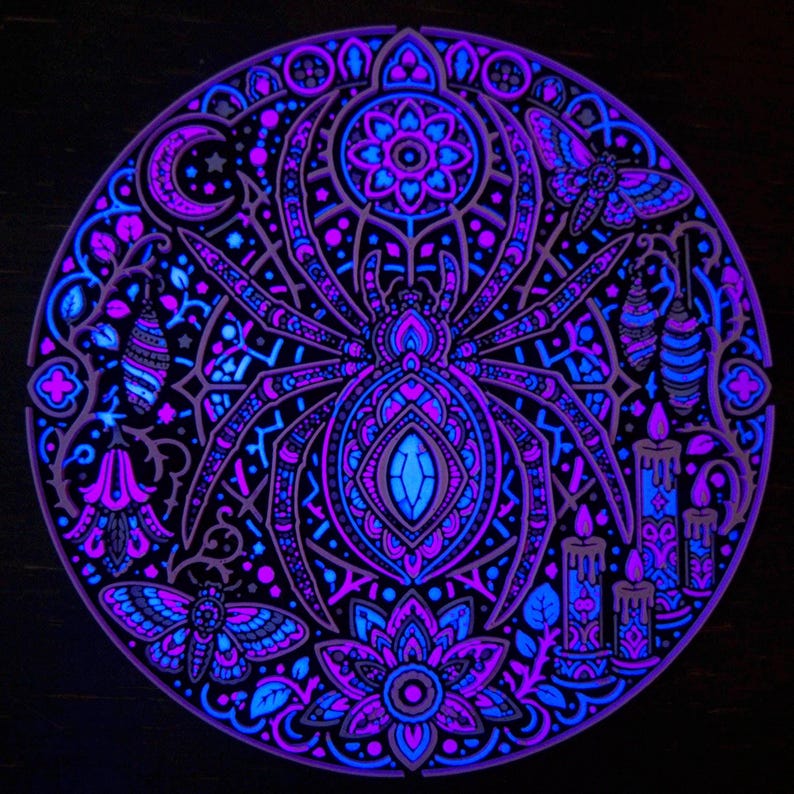 Complete Arachnomancer spider wall relief under active UV blacklight.