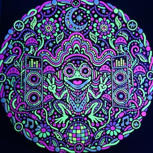 Full circular Bass Frog wall relief glowing in neon pink, yellow, and green under active UV blacklight.