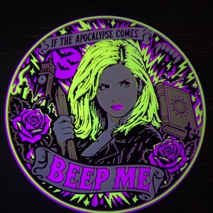 Complete Slayer wall relief under active UV blacklight, showing vivid reactive yellow, magenta, and violet details.