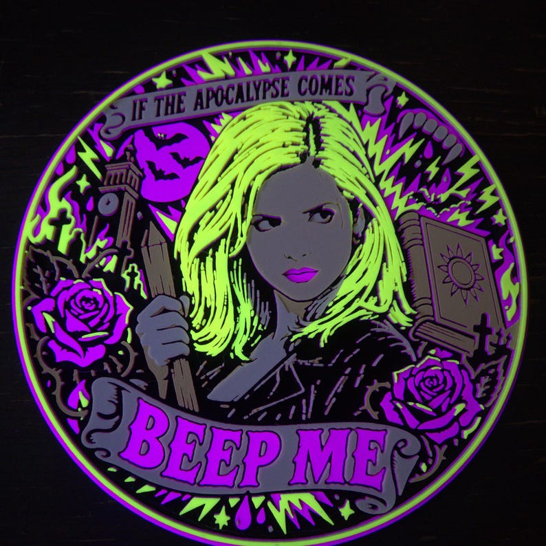 Complete Slayer wall relief under active UV blacklight, showing vivid reactive yellow, magenta, and violet details.