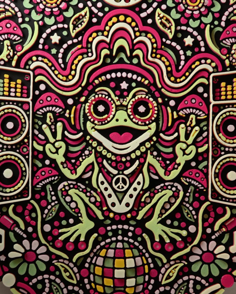Close-up of the smiling Bass Frog character wearing headphones between the speaker stacks.