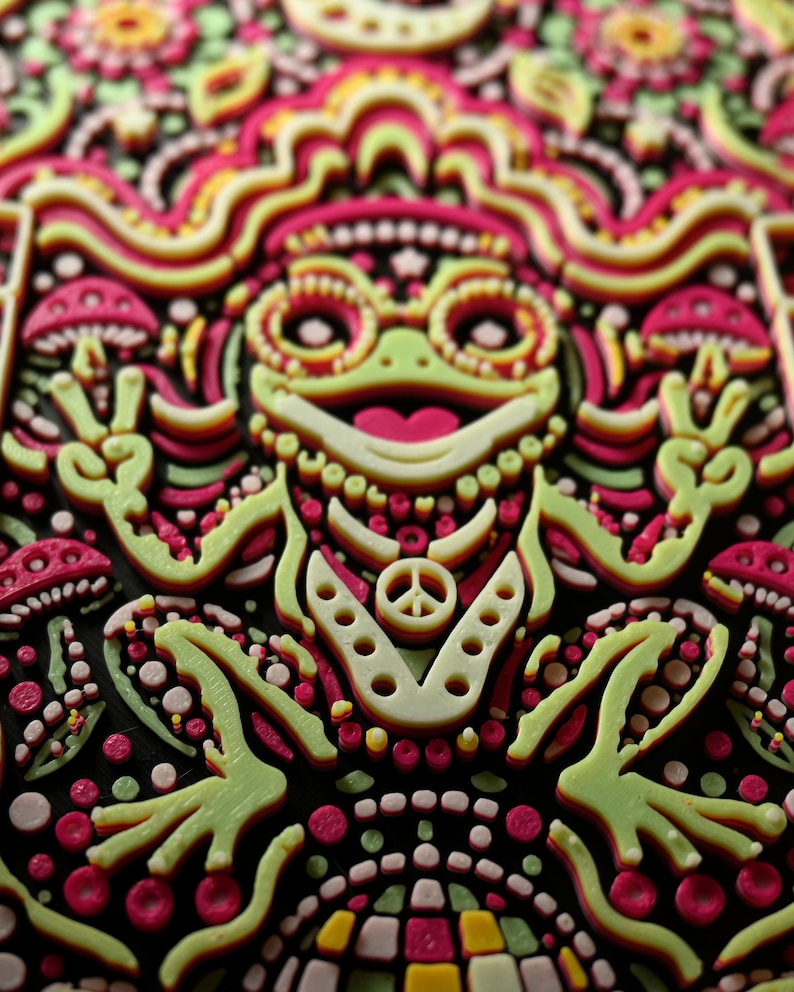 Raking-light close-up showing the raised layered texture of the frog and surrounding relief details.