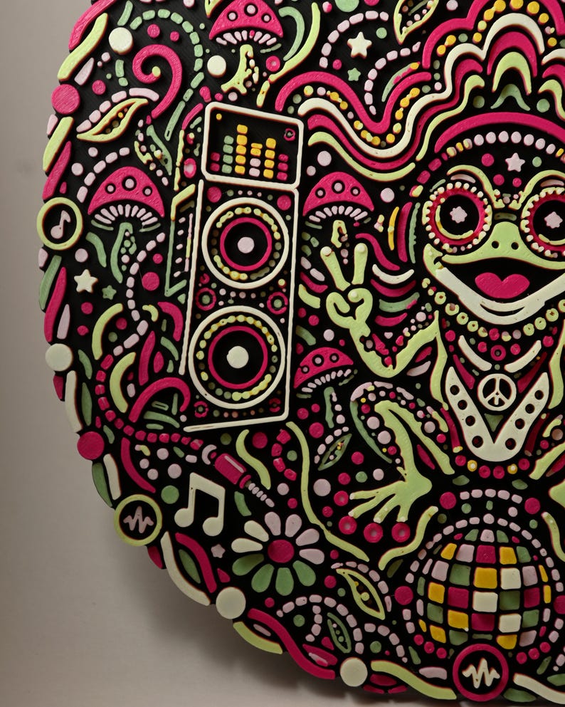 Angled daylight close-up of Bass Frog’s left edge, speaker, mushrooms, and raised layered relief details.