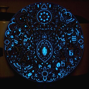 Complete Arachnomancer wall relief after the UV source is removed, showing retained afterglow.