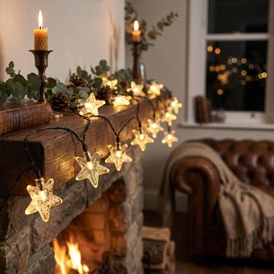 May include: A string of clear, star-shaped LED lights with a textured finish, draped across a wooden mantelpiece. The lights emit a warm glow, illuminating the surrounding greenery and pinecones, creating a soft, ambient lighting effect.