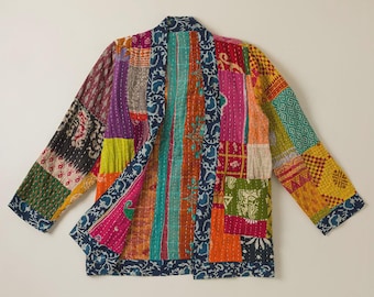 May include: A long-sleeve jacket constructed from a patchwork of multicolored fabric panels featuring various floral, geometric, and paisley patterns in shades of pink, orange, yellow, green, and blue, finished with a dark blue patterned trim.