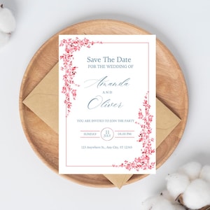 Op de afbeelding: Een rechthoekige Save the Date trouwkaart met roze aquarel bloemenranken langs de linker- en onderrand. De tekst luidt: Save The Date FOR THE WEDDING OF Amanda AND Oliver YOU ARE INVITED TO JOIN THE PARTY SUNDAY 11 JULY 04:00 PM 123 Anywhere St., Any City, ST 12345.