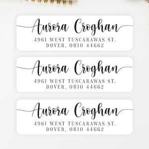 May include: Three rectangular white address labels featuring black text. Each label displays the name Aurora Croghan in a cursive script font, followed by the address 4961 West Tuscarawas St. Dover, Ohio 44662 printed in a clean serif typeface.