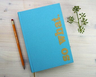 NOTEBOOK, A5 with Silkscreenprinting 'so what' on Cover