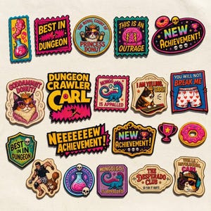 May include: A collection of colorful embroidered patches featuring various designs including cats wearing crowns, a donut, skulls, trophies, and text such as "Best in Dungeon," "Princess Donut," "New Achievement," "Dungeon Crawler Carl," and "Monggo is Appalled."