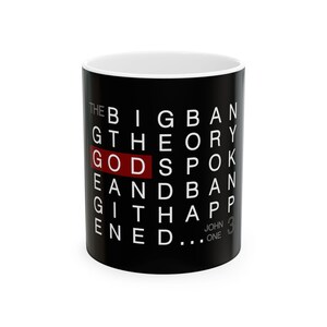 May include: A black ceramic mug with white text that reads THE BIG BANG THEORY GOD SPOKE AND BANG IT HAPPENED. The word GOD is highlighted in a red rectangular box. The text JOHN ONE 3 is printed in small grey letters at the bottom right.