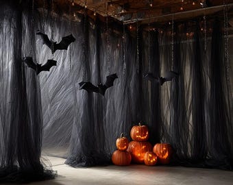 May include: A collection of five orange jack-o'-lanterns with carved faces and internal lighting, positioned in front of floor-to-ceiling black sheer fabric curtains. Several black bat silhouettes hang from the ceiling on thin chains.