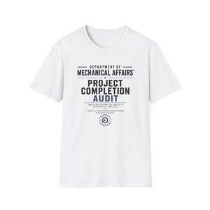 May include: A white short-sleeve t-shirt featuring black and blue text that reads Department of Mechanical Affairs, Project Completion Audit, Inspection confirms the project is mechanically complete, Cosmetic improvements remain under continuous review.