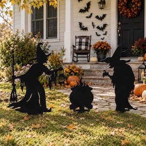 May include: A set of three black metal yard stakes featuring silhouettes of two witches and a cauldron. One witch holds a broom and a lantern, while the other stands with hands outstretched. The figures are designed for outdoor display.