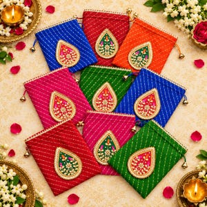 May include: A collection of nine rectangular fabric drawstring pouches in vibrant colors including red, blue, orange, pink, and green. Each pouch features a diagonal striped pattern and a central teardrop-shaped embroidered patch.