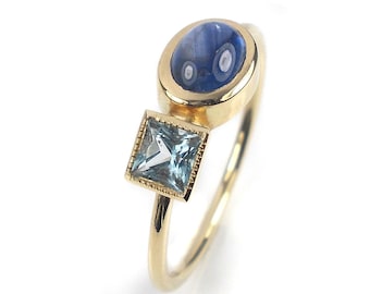 Bague romantique avec un saphir ovale et une topaze bleue carrée