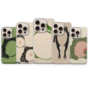 Puede incluir: Cinco fundas transparentes para smartphone con diversas ilustraciones artísticas de ranas. Los diseños incluyen motivos de ranas en tinta verde y negra, patrones circulares y siluetas minimalistas de ranas sobre fondos crema y verdes.