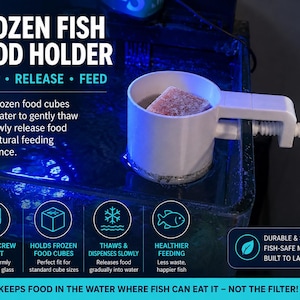 May include: A white plastic frozen fish food holder with a screw mount mechanism for aquarium glass. The device features a cylindrical cup to hold frozen food cubes, allowing them to thaw and release into the water for aquarium fish feeding.