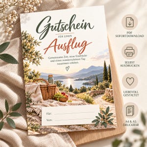 May include: A gift voucher featuring the German text Gutschein für einen Ausflug, with an illustration of a picnic basket, grapes, and a lake landscape. The card includes lines for names and four circular icons with text on the right side.