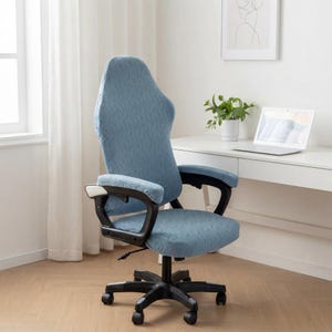 May include: A high-back office chair featuring a textured, light blue fabric cover with a subtle wavy pattern. The chair includes black armrests, a black five-point base with casters, and an adjustable seat height mechanism for ergonomic support.