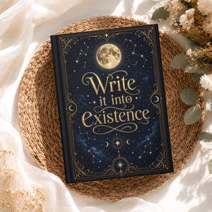 May include: A dark blue hardcover journal featuring a gold foil celestial design with a full moon, stars, and constellations. The cover displays the text Write it into Existence in elegant gold lettering surrounded by intricate decorative borders.