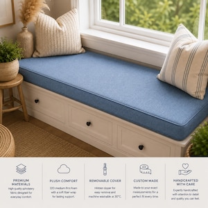 May include: A rectangular blue fabric bench cushion with a smooth texture, designed to fit a window seat. The cushion features a clean-edged construction and is displayed on a white wooden base with three drawers and small black knobs.