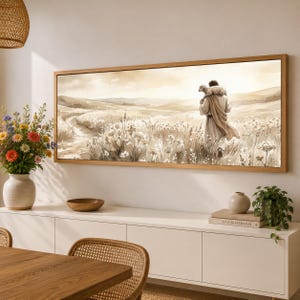 May include: A horizontal rectangular wall art print in a wooden frame depicting a figure in robes walking through a field of wildflowers while carrying a small lamb on their shoulders, rendered in a soft sepia and beige watercolor style.