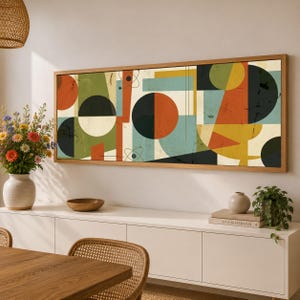 May include: A rectangular wall art piece in a wooden frame featuring a geometric abstract composition. The design includes circles, triangles, and lines in shades of orange, olive green, teal, black, and cream with a distressed texture.