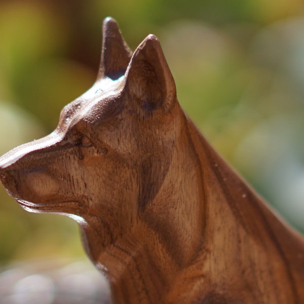 German Shepherd Statue or Sculpture. Carved from a solid block of Walnut. This Figurine is in a Sitting pose. Available in different sizes.