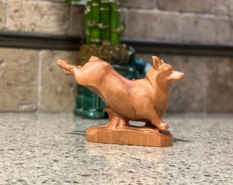 Corgi Satue or Sculpture. Carved from a solid block of Cherry. This Figurine is in a running pose. Made from Solid Cherry hardwood.