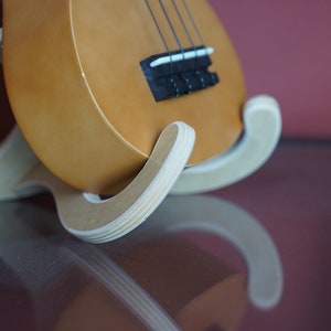 Plywood ukulele stand. 2 peices slide into place to make a sturdy base for your ukulele or small guitar.