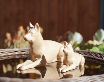 White German Shepherd Figurine or Sculpture. Carved from a solid block of Maple. In a lying pose. Available in different sizes.