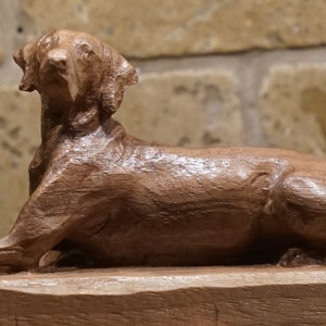 Labrador/Weimaraner Figurine or Sculpture. Made of Solid Walnut and Different hardwoods. Carved from a solid block of hardwood. Laying.