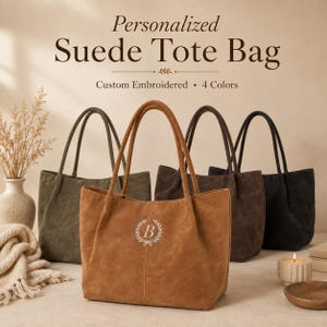 May include: Four suede tote bags in olive, tan, brown, and black. The tan bag features a white embroidered letter B inside a laurel wreath. Text above reads: Personalized Suede Tote Bag, Custom Embroidered, 4 Colors. Each bag has two handles.