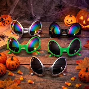 May include: Five pairs of alien-themed sunglasses with oversized, rounded frames. Two pairs feature silver frames with rainbow-tinted lenses, one pair has black frames with rainbow lenses, one pair has green frames with rainbow lenses, and one pair has silver frames with dark lenses.