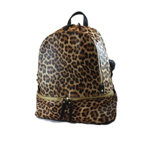May include: A brown and black leopard print backpack with gold zipper accents.