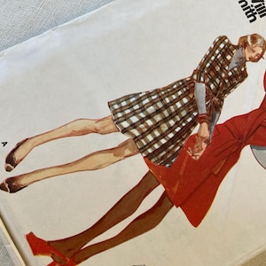 May include: Vintage sewing pattern featuring illustrations of two figures in stylish outfits. One figure wears a plaid coat dress, the other a red dress. The pattern is labeled "Villi Smith" in the upper right corner.