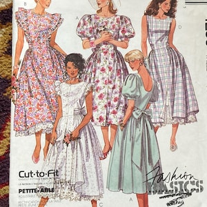 May include: A sewing pattern for four dresses. The pattern is for sizes 8, 10, and 12. The dresses are all different styles, with some having puffed sleeves, some having lace trim, and some having a plaid pattern. The pattern is called "Fashion Basics" and the number is 4250.