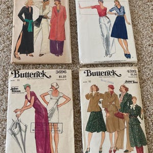 May include: Four vintage Butterick sewing pattern envelopes. The patterns feature illustrations of women's clothing designs, including dresses, coats, and separates. The envelopes display the brand name, pattern numbers, and designer names. The designs are from the 1970s and 1980s.